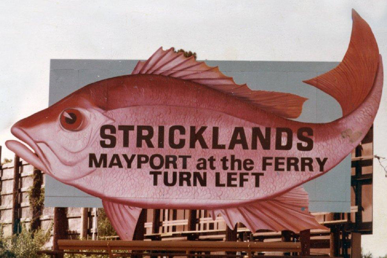 Historical Billboard featuring a large fish that references Well-known Strickland's Restaurant and the Ferry.